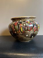 Side view of the ceramic flower pot showing the multicolor glaze decoration