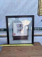 Framed silk screen artwork by Mauro with measuring tape showing approximately 18 inches width.