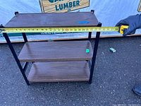 Shelf width measured with tape measure shows 24 inches approximately