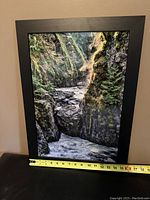 Front view of framed Brian Nicol photography with measuring tape showing width approx. 16 inches.