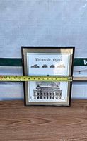 Framed art print showing front elevation of Théâtre de l'Opéra. Tape measure indicates width about 15 inches.