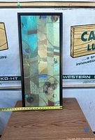 Full front view of the 16x36 framed abstract picture showing colors, shapes, and black frame.