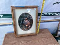 Photo showing the 3D owl picture frame, vertical orientation with a tape measure indicating height 16 inches.