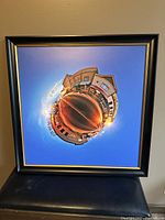Framed circular panoramic art print showing a town street and sunset sky.