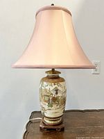 Full front view of lamp showing shade, porcelain base and rosewood stand