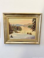 Frontal photo of the W E Schmidt winterscape oil painting on board, showing the entire piece with frame.