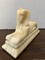 Side view of the veined marble sphinx lamp showing sculpted details and shape