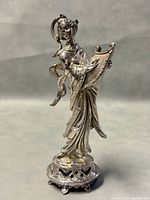 Front angle of the sterling silver Chinese woman statue showing detailed robes, harp, and raised base.
