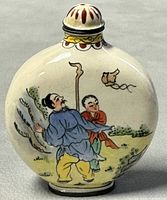 Front view of the snuff bottle showing two men walking and a flying bird.