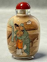 Front view showing detailed painting of a man embracing a woman indoors with a hanging lantern and furniture background.