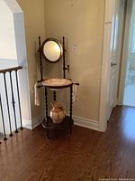 Full view of the vintage wooden washstand with mirror, ceramic bowl, pitcher, and towel