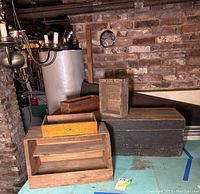 View of four wood boxes including a large black box, a small crate, a drawer, and a multi-tier wooden organizer