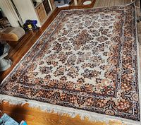 Full view of large wool carpet showing pattern and fringe condition