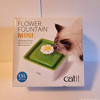 Box of Catit Flower Fountain Mini cat drinking fountain showing 1.5 liter capacity and product image with a cat drinking.