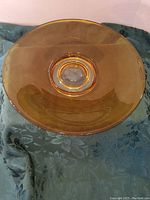Top view of the yellow amber glass dish showing the smooth surface and clear circular center.
