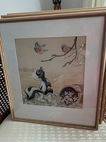 Full view of framed painting showing skunk and birds in scene