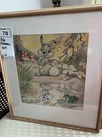 Front view of framed artwork leaning against chair