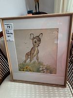 Full frontal view of the framed painting resting on chair