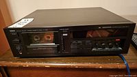 Front view of Yamaha cassette deck on wooden surface