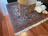 Overall view of machine woven cotton area rug with bamboo coffee table