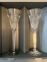 Pair of Waterford crystal champagne flutes in original box showing full length and design