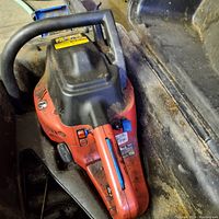 Top view of the red and black Homelite chainsaw showing the handle and engine casing.