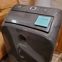 Front view of black Hisense portable air conditioner with visible Hisense logo and handle.