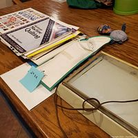 Light table, quilting books, and how-to document arranged on wooden table