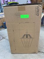 Box showing the brand Lutec and the dimensions of the lamp: 21 inches high by 12.2 inches wide. Box is unopened.
