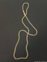 Cable chain necklace displayed on black background