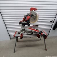 Front view of Milwaukee miter saw mounted on wheeled stand
