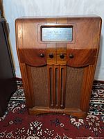 Full front view of wooden console radio showing overall cabinet design.