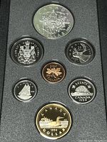 Photo of the obverse side of the 1994 Canadian Silver Proof Coin Set showing the reverse designs of all coins including Double Dollar with Northern Dog Team Patrol