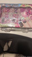 Front view of sealed Fancy Nail Patch kit showing colorful patches, nail file, and manicure stick inside plastic case