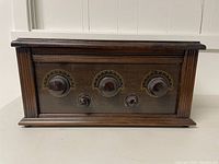 Front view of the antique Serenader radio showing wood case and control knobs.