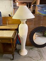 Full view of the vintage white floor lamp showing pleated column base and white lampshade.