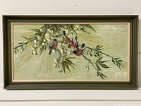 Full view of the framed oil painting showing four red birds perched on a flowering branch with a muted green background.