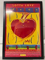 Full view of framed 'Lotta Love' poster showing heart artwork and event details