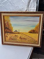 Full view of the oil painting on canvas in its decorative frame showing the prairie landscape with barn, windmill and trees.