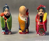 Front view of the three hand painted Asian figurines showing details and scale.