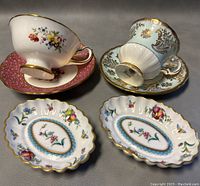 Top and side view of both teacups and saucers with the two olive dishes placed in front, showing detailed patterns and condition.