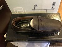 Top view of brown leather shoe showing brand name J. Sabat inside and memory foam label, sitting on J. Sabat shoe box.