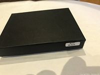 Closed black box with label '3177 BLACK' on the side showing packaging of the money clip.