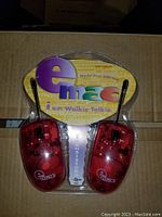 Pair of Emac i am Walkie Talkie devices in red translucent plastic, new and packaged in original blister pack with colorful logo and text.
