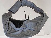 Over the shoulder adjustable pet carrier laid out showing mesh window and clip