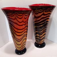 Pair of large Murano art glass vases with wavy black stripes, red rim, and black base shown together.