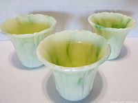 Three Akro Agate slag glass planters with scalloped rims and green-white agate swirl pattern, no visible chips or cracks.