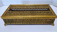 Front angled view of the vintage brass tissue box showing the intricate filigree design and gold finish.