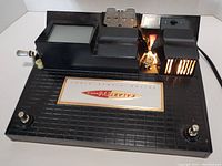 Front angled view of the Kalart EV-8 Editor Viewer showing the black textured base, the built-in viewing screen, film clip holder, and light unit on the right side.