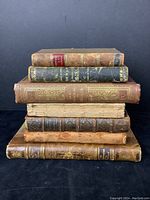 Stack of seven antique leather bound books